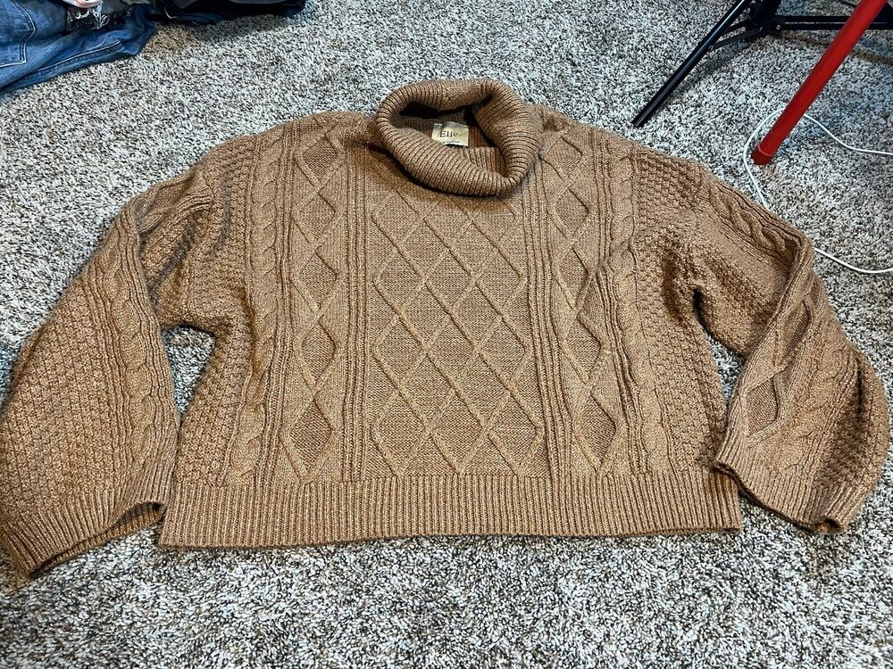 Ellie Tahari cable knit sweater features a chunky cowl neck design